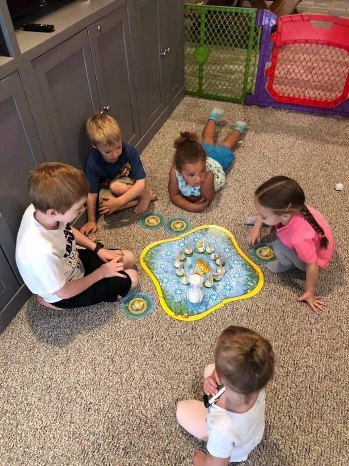 Children playing a board game on the floor