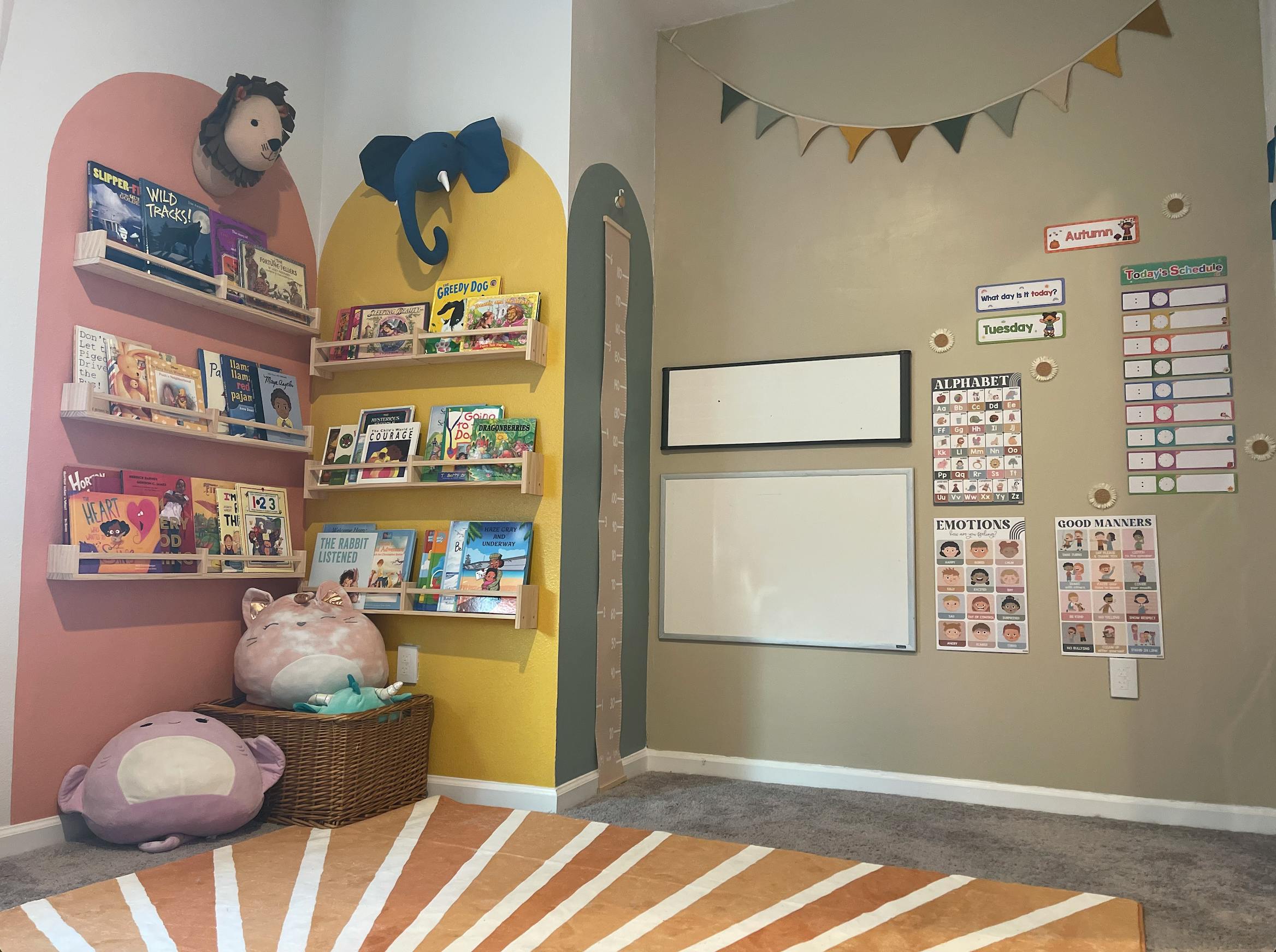 Children's room with bookshelves, wall decorations, and whiteboards