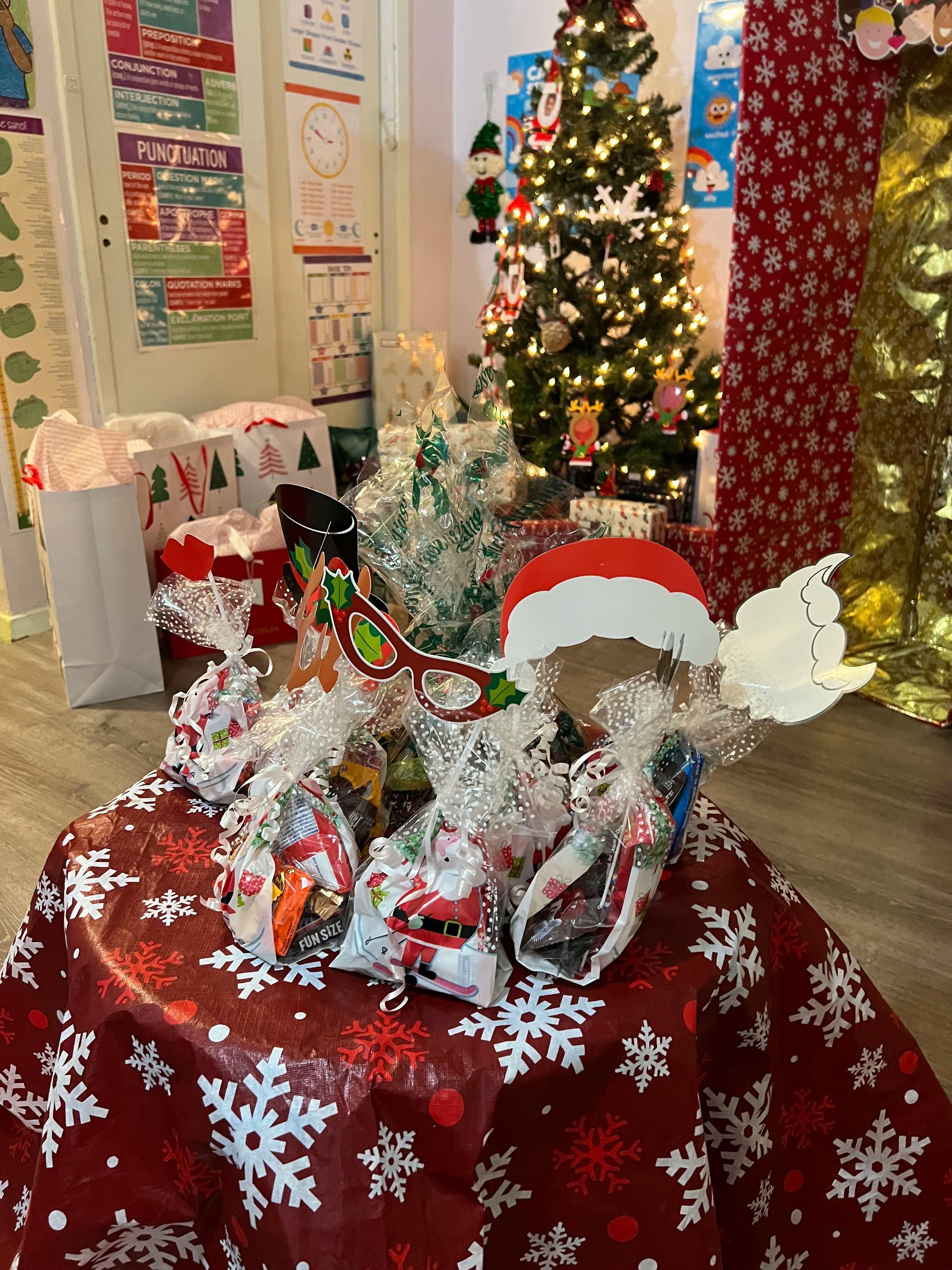 Table with wrapped gifts and holiday decorations