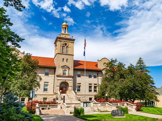 large building with a tall bell tower and red tiled roof