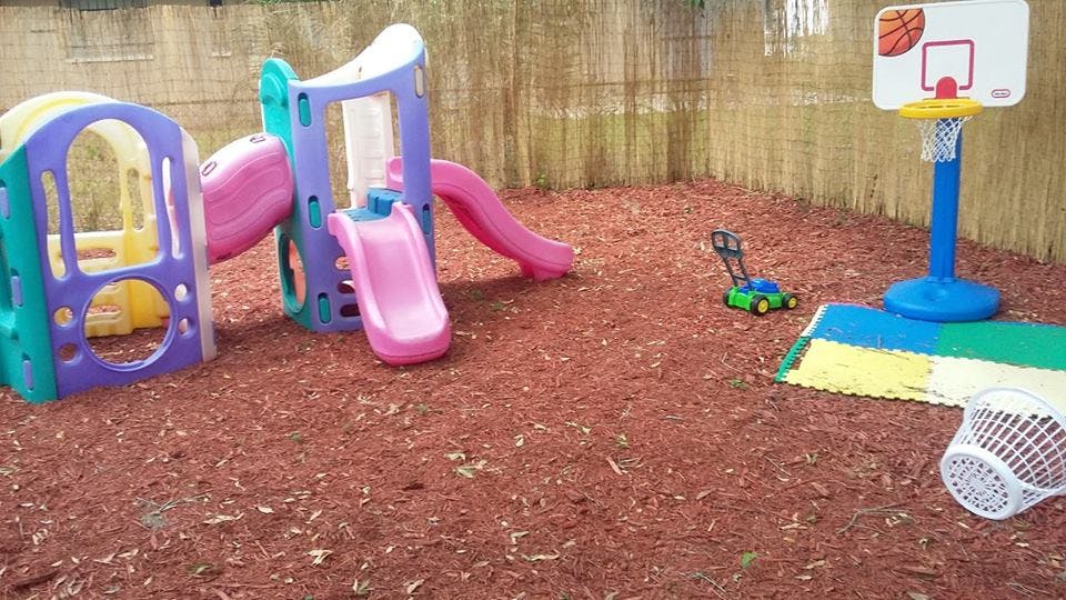 Playground with slides, basketball hoop, and toy lawnmower