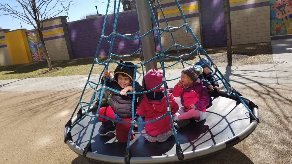 Children playing on a rope climbing structure