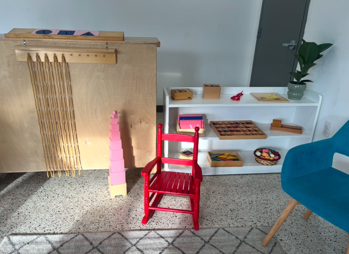Red child's chair in a room with learning materials