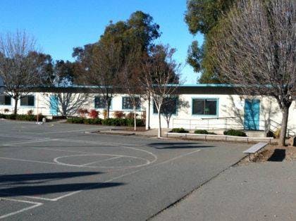 Portable classroom buildings with a paved play area in front