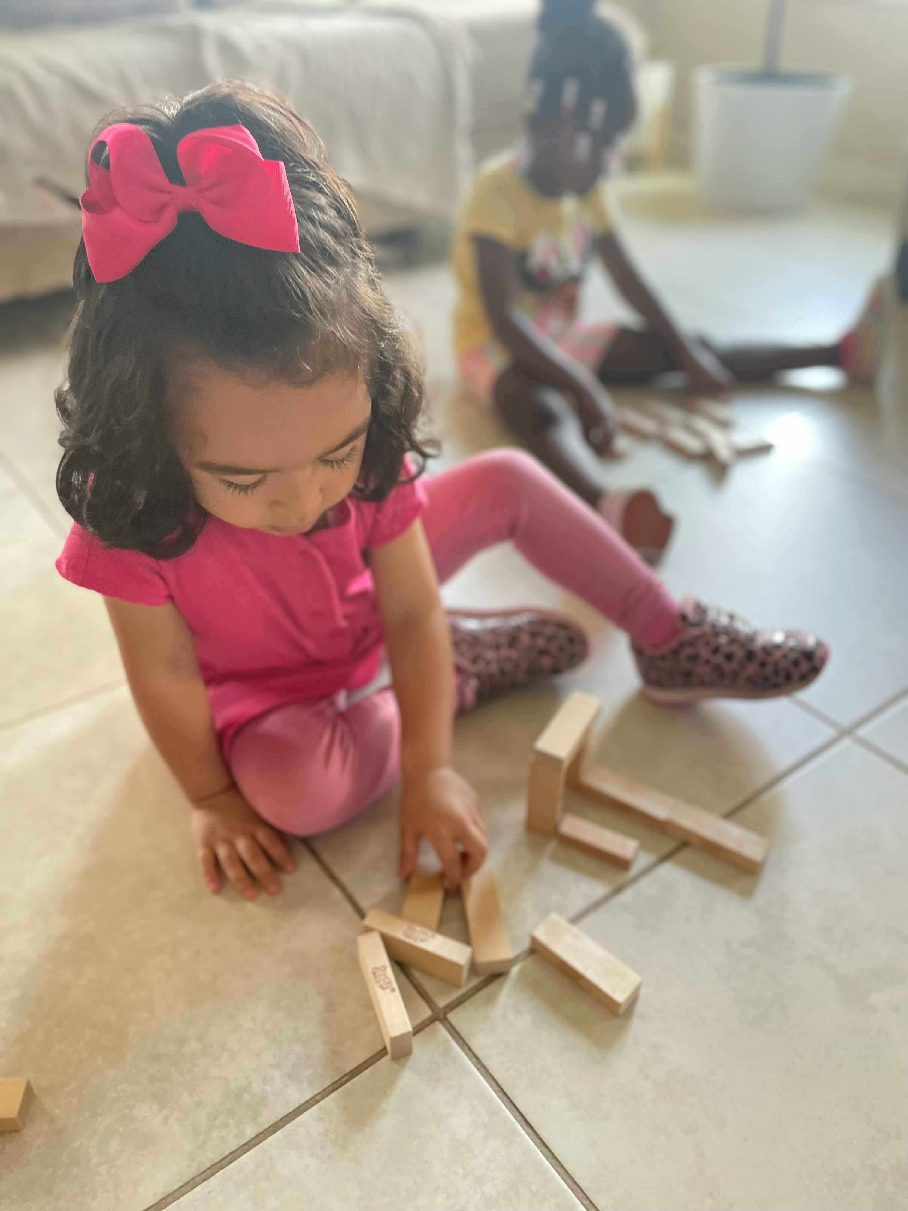 Child playing with wooden blocks on the floor