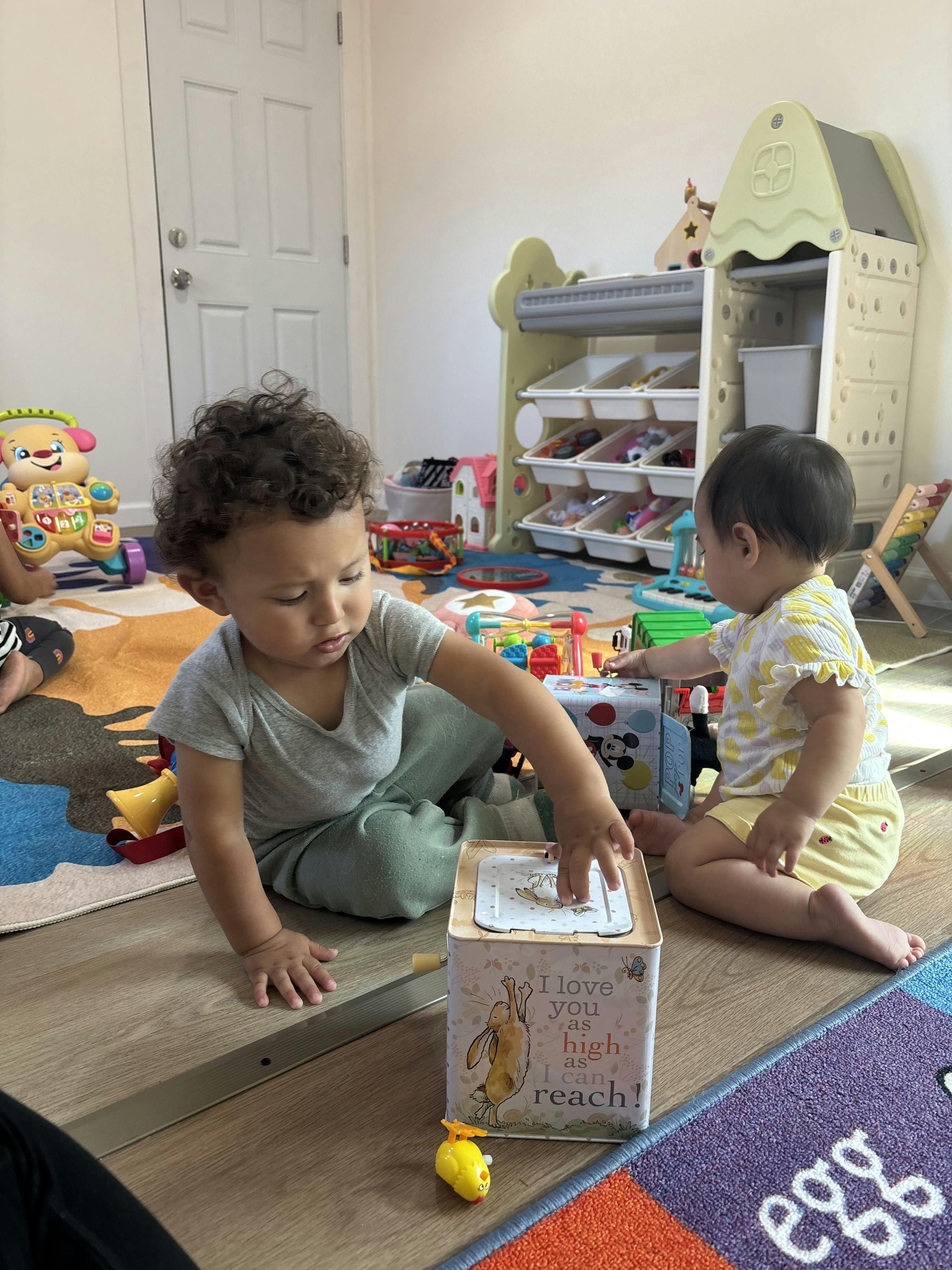 Two children playing with toys on the floor
