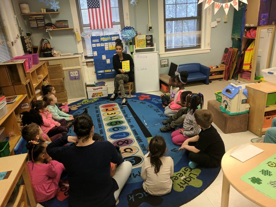 Person reading to children in a classroom