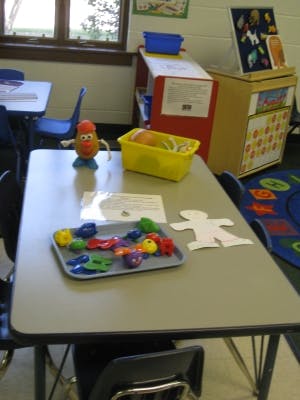 Mr. Potato Head toy and colorful shapes on a table