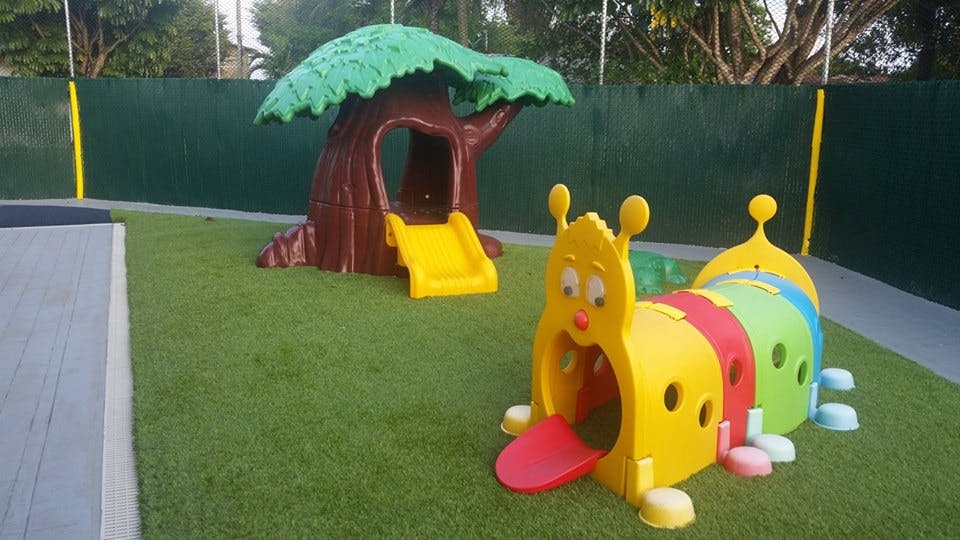 Playground with a tree-shaped slide and a caterpillar tunnel