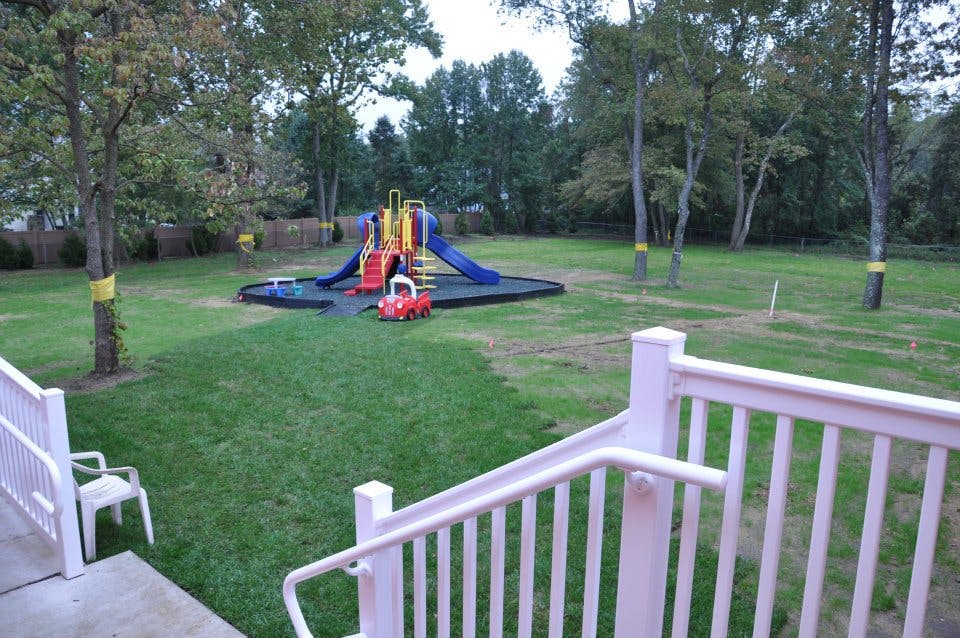 Playground with slides and swings in a grassy yard
