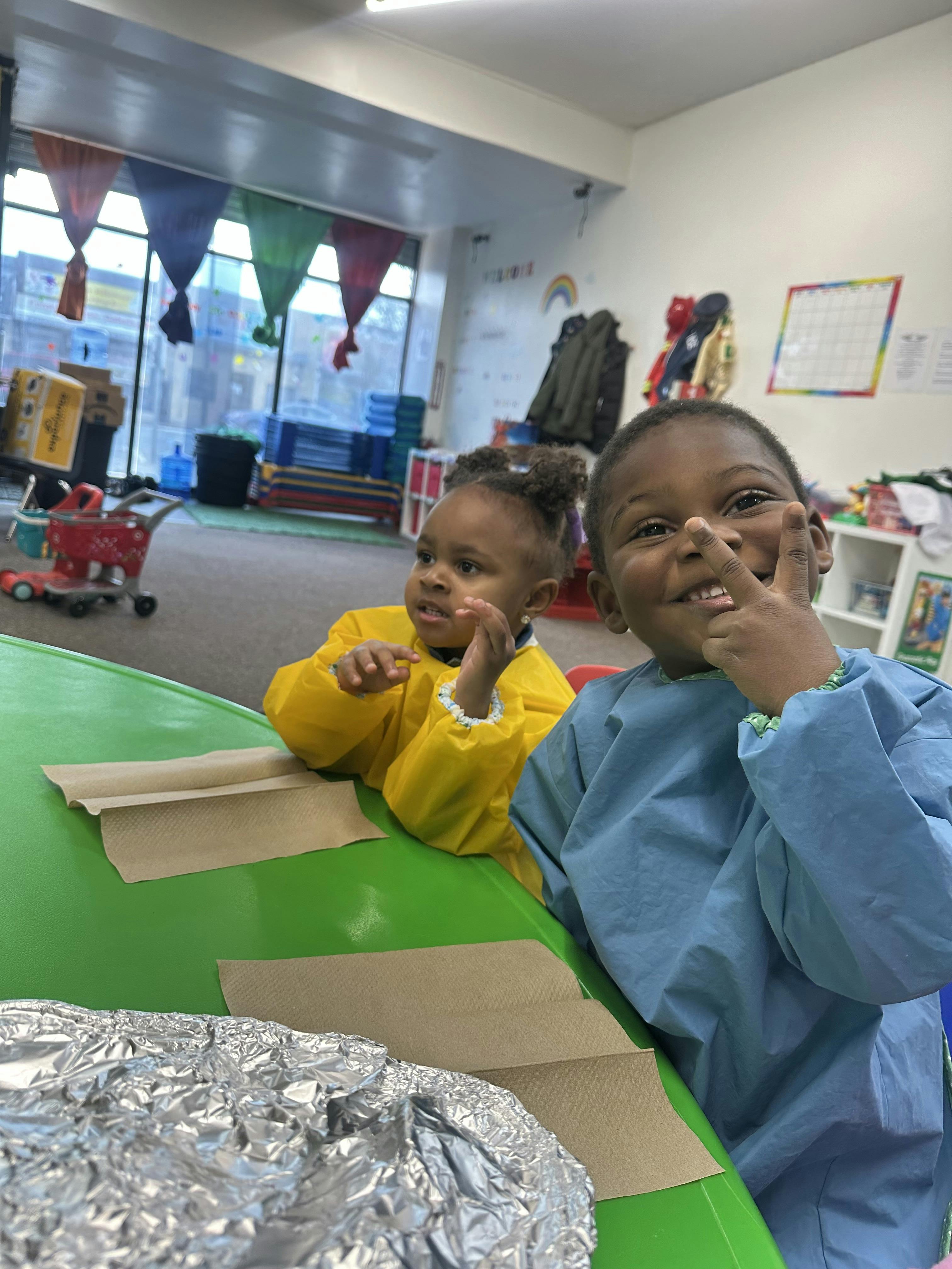 Two children at a table in a classroom