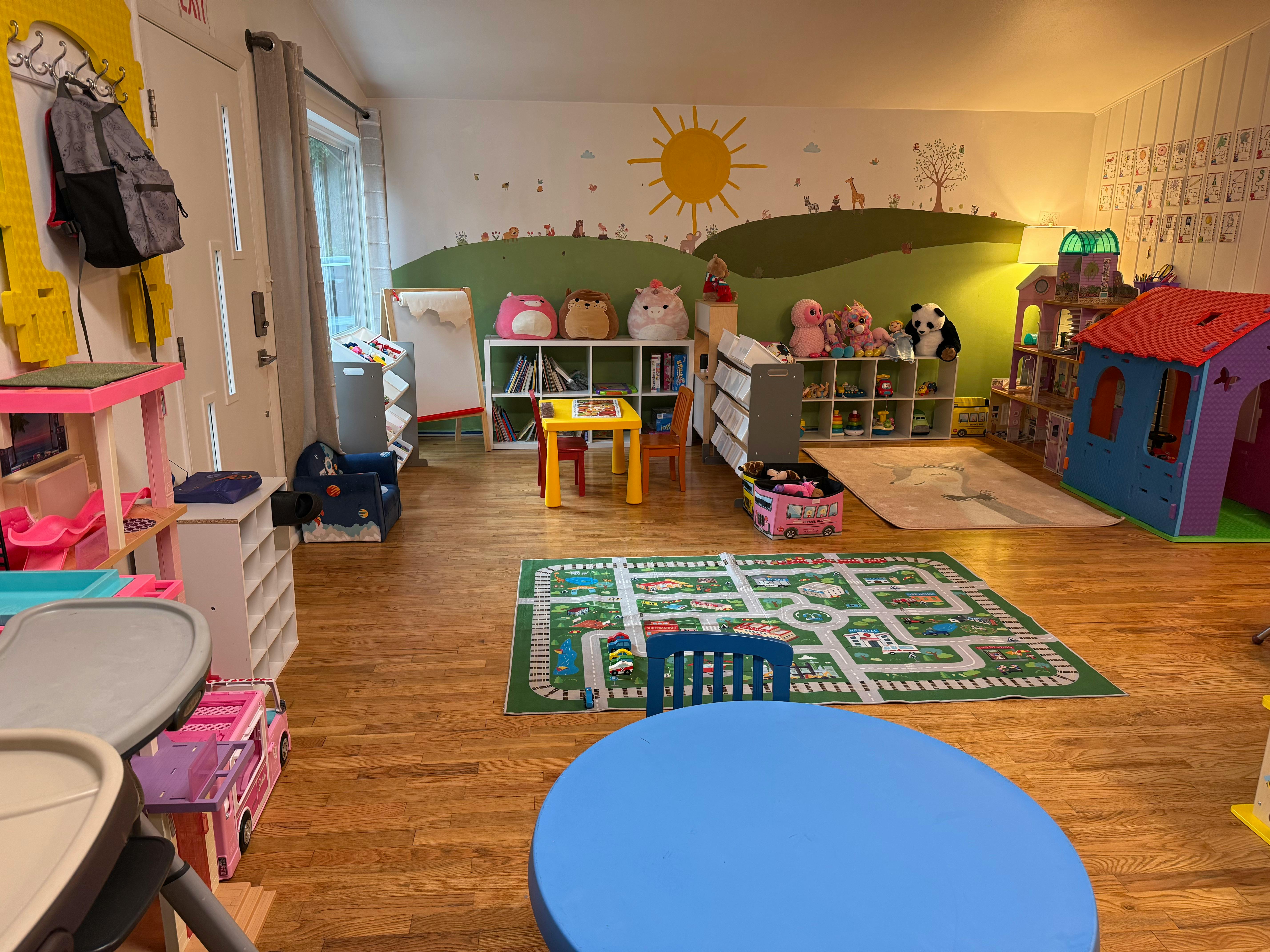 Child's playroom with toys and wall mural