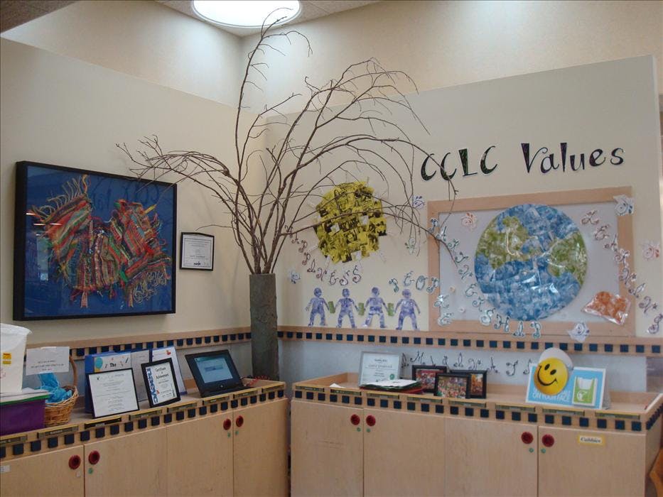Room with children's artwork, including a large earth and text "CCLC Values"