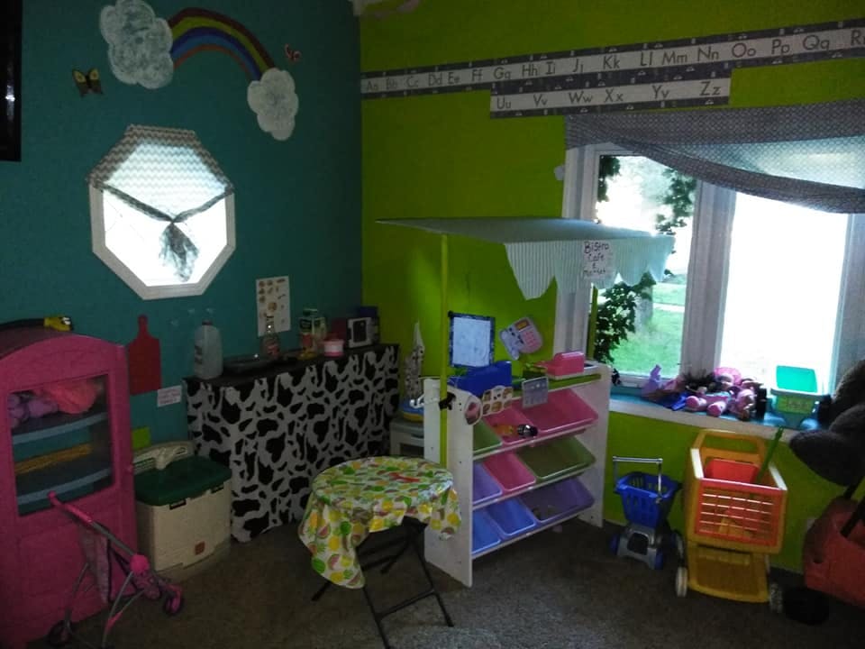 Playroom with toys, shelves, and a small table
