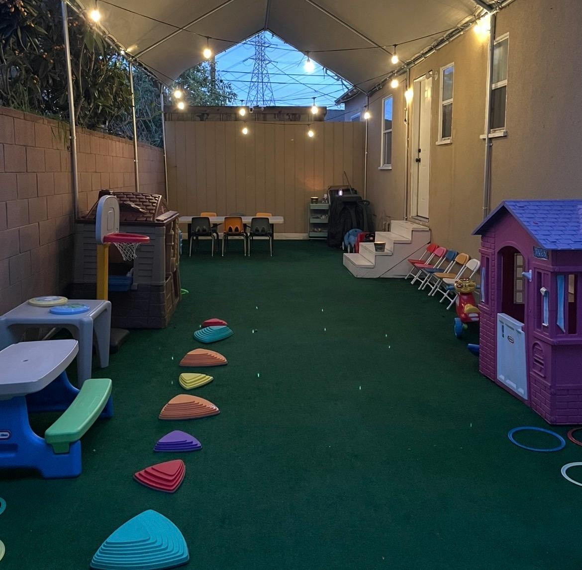 Outdoor children play area with toy houses and a path of stepping stones