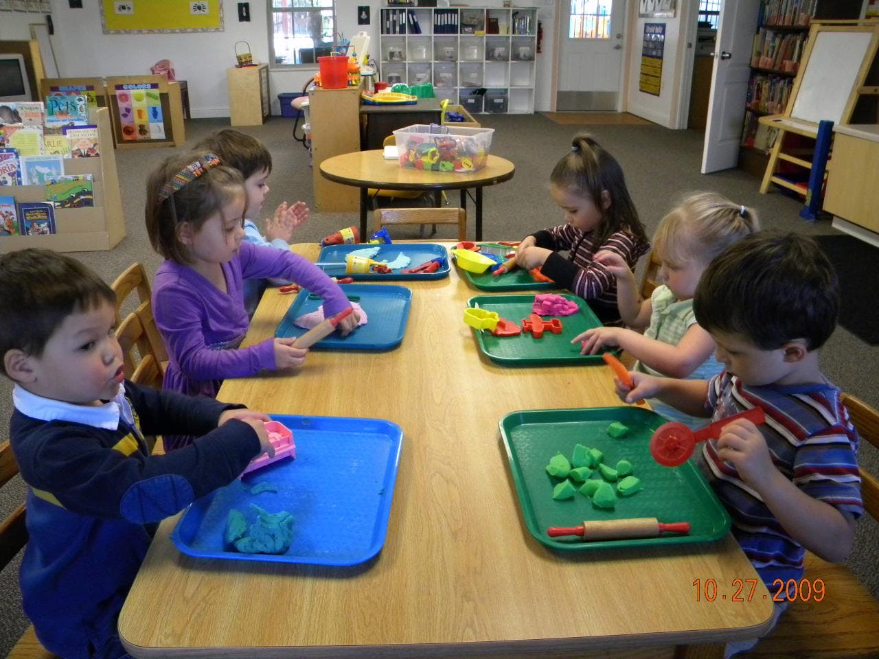 Children playing with modeling clay at a table