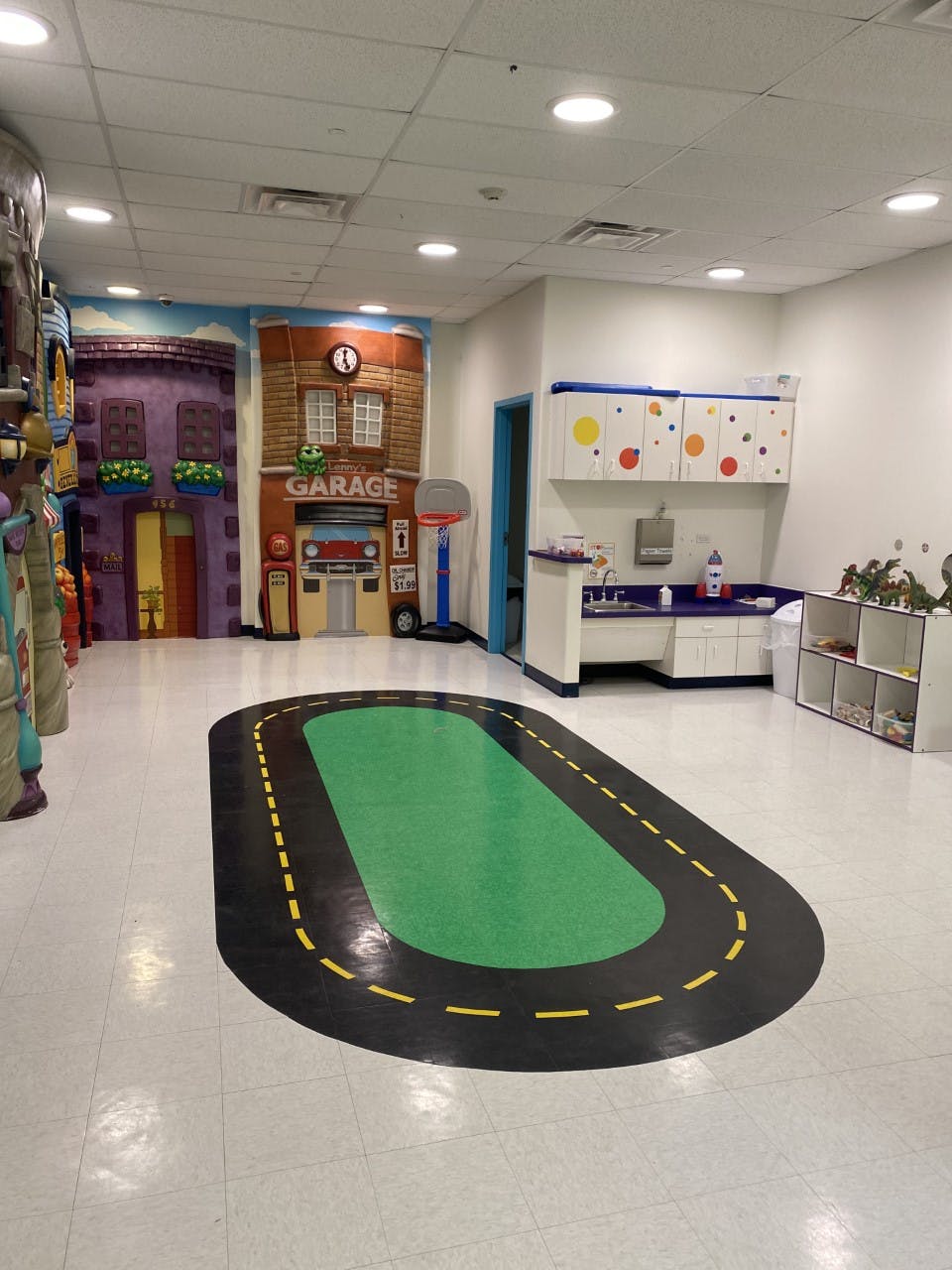 Playroom with a road mat on the floor and building facades on the wall