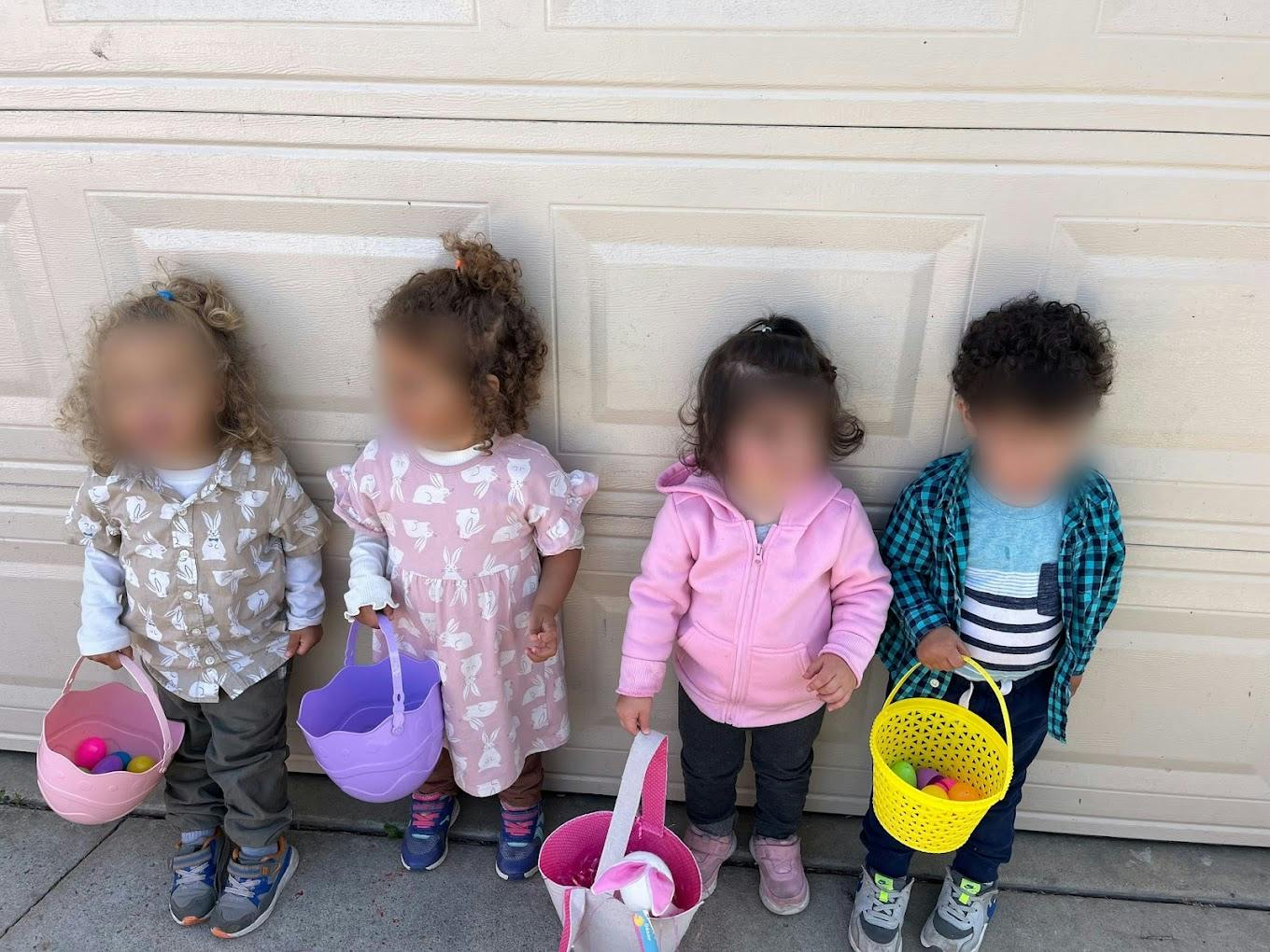Four children standing with baskets
