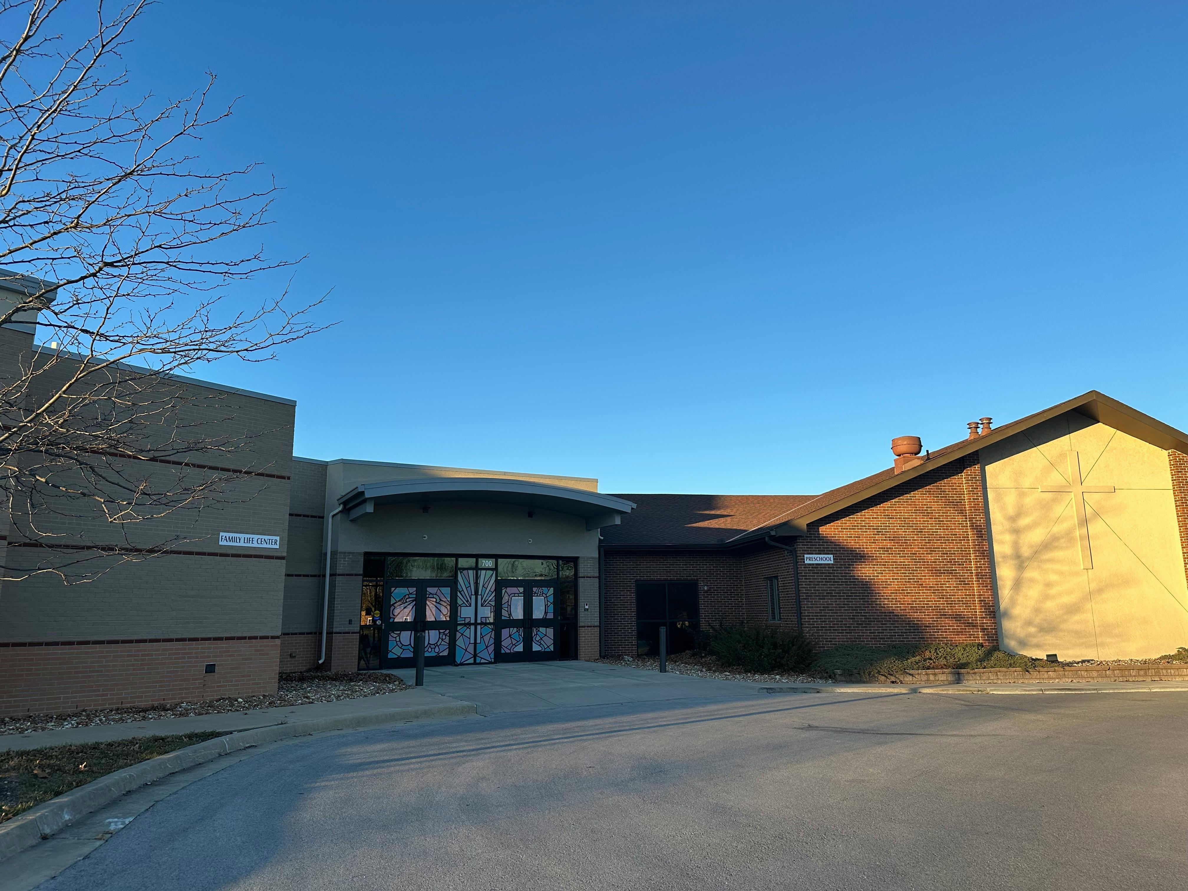 Exterior of a building with a curved entrance and glass doors