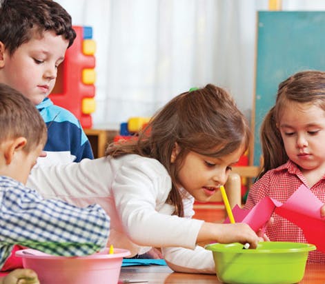 Children doing crafts with bowls and paper