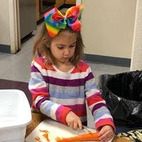 Child cutting a carrot