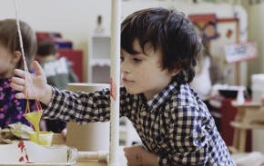 Child playing with a toy in a classroom