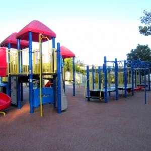 Playground with red roofs and blue and yellow structures