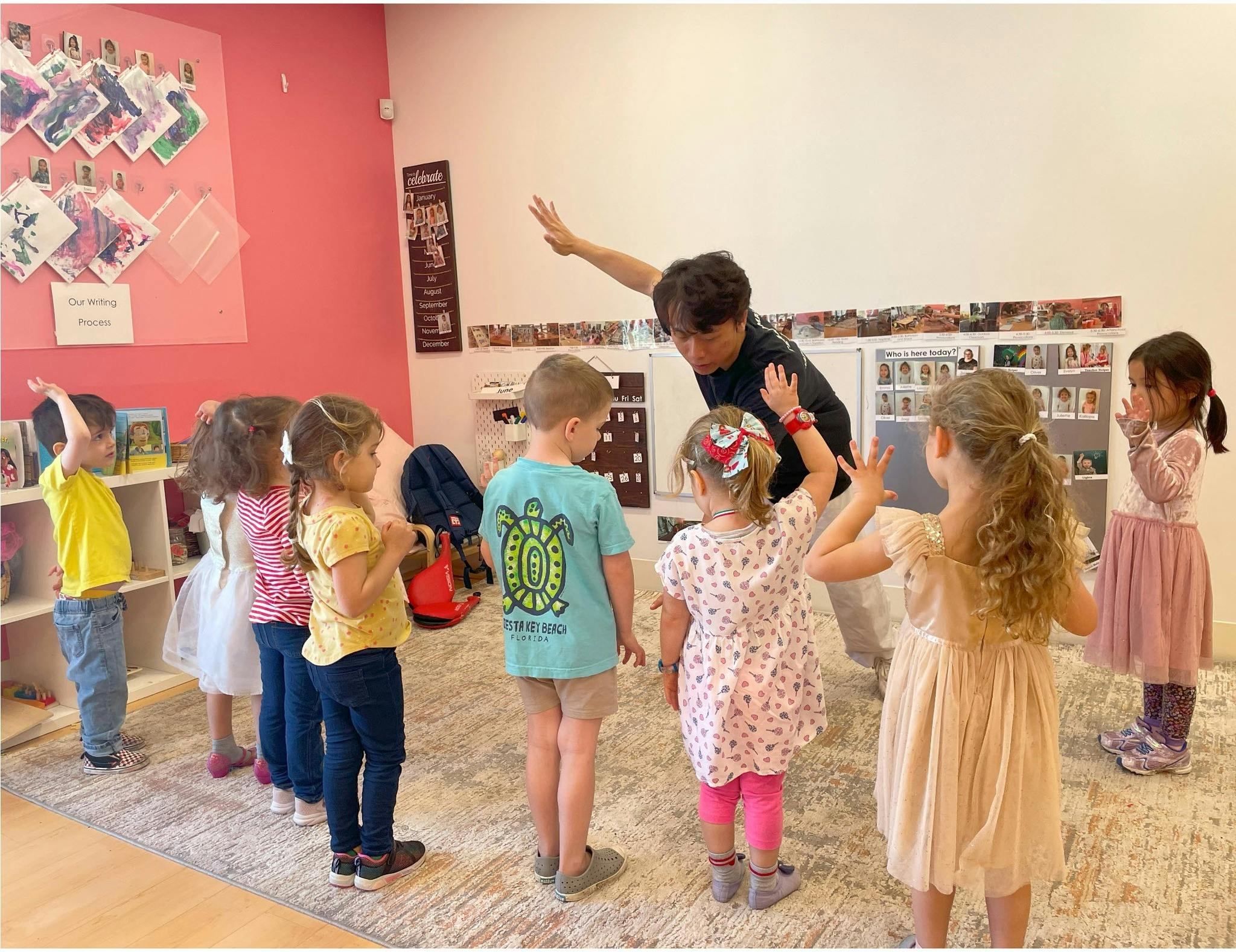 Person leading a group of children in an activity