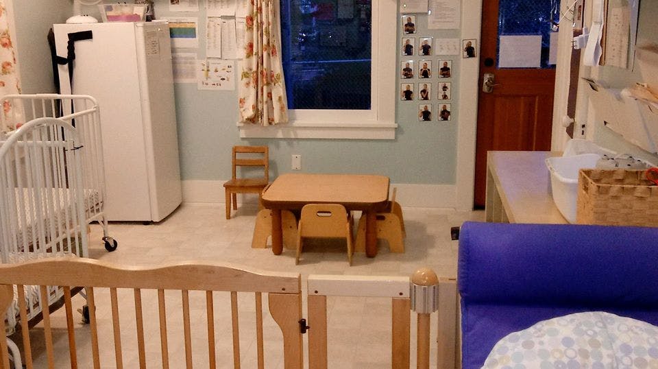 Child's room with crib, small table and chairs, and playpen
