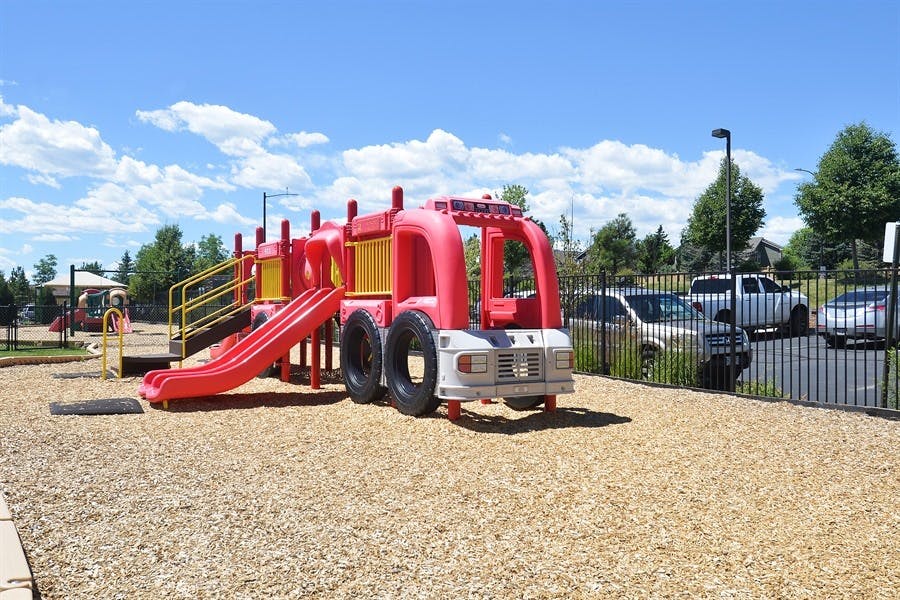 Red fire truck playground structure with slide
