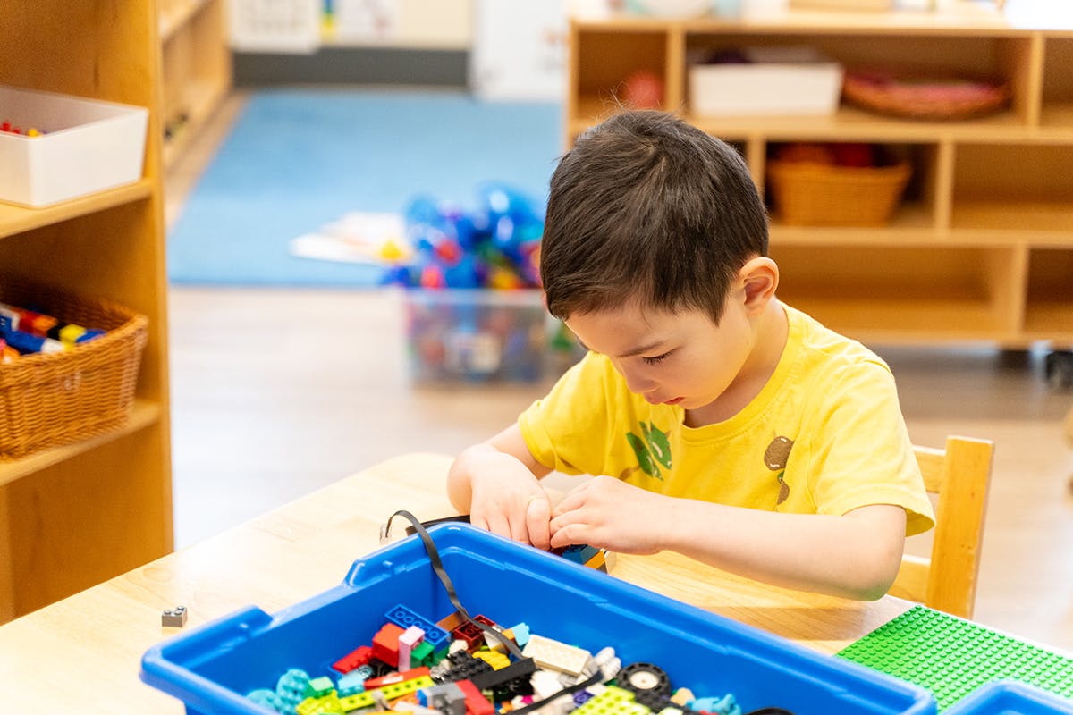 Child playing with building blocks at a table