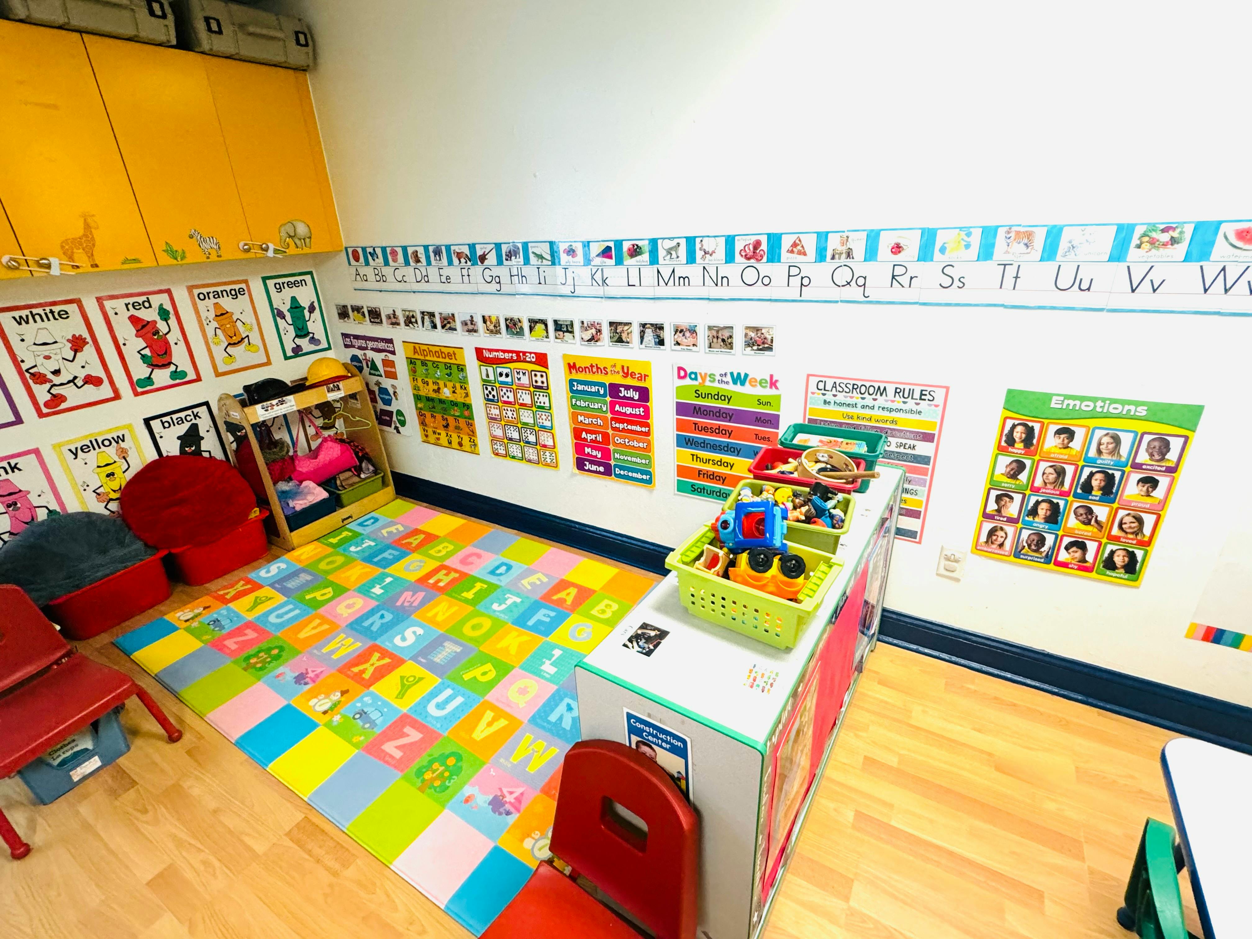 Classroom with alphabet rug, posters, and toys