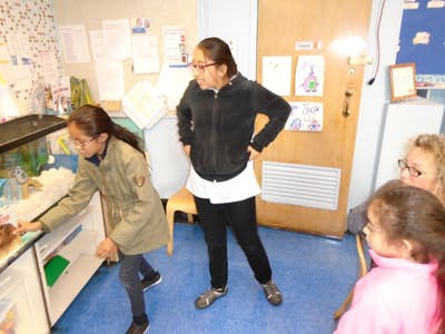 Two teens and two children in a classroom