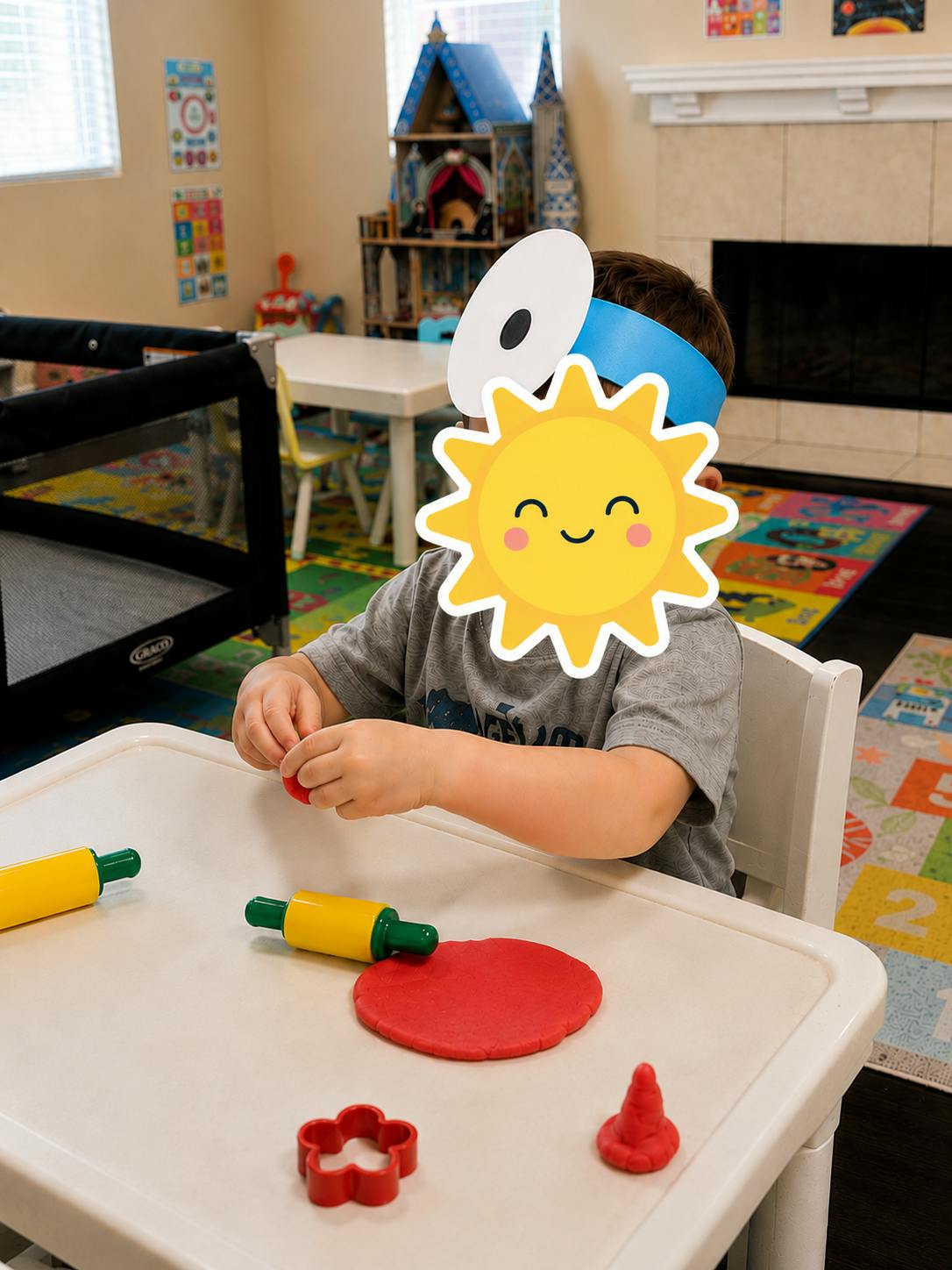 Child playing with modeling clay and rolling pins at a table
