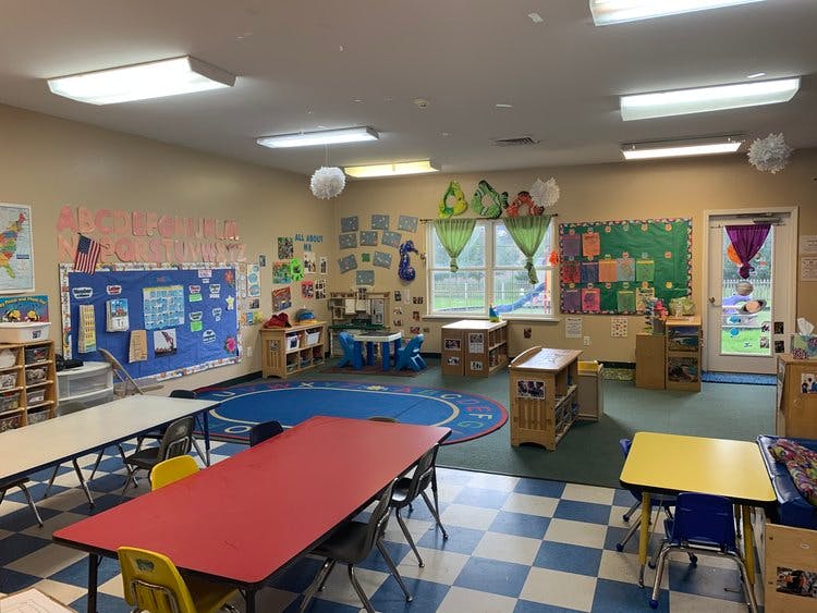 Empty classroom with small tables and chairs