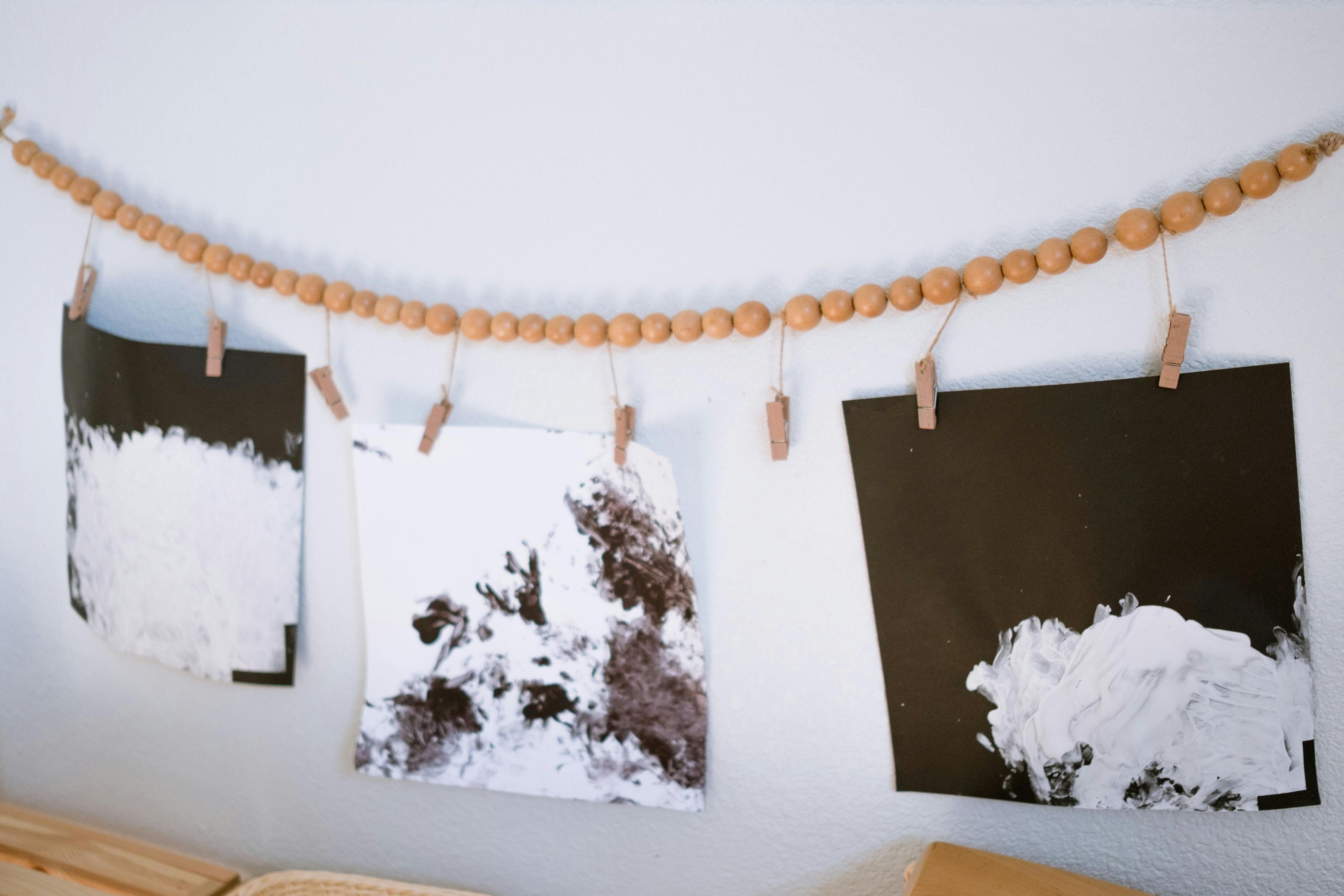 Children's artwork hanging on a beaded garland