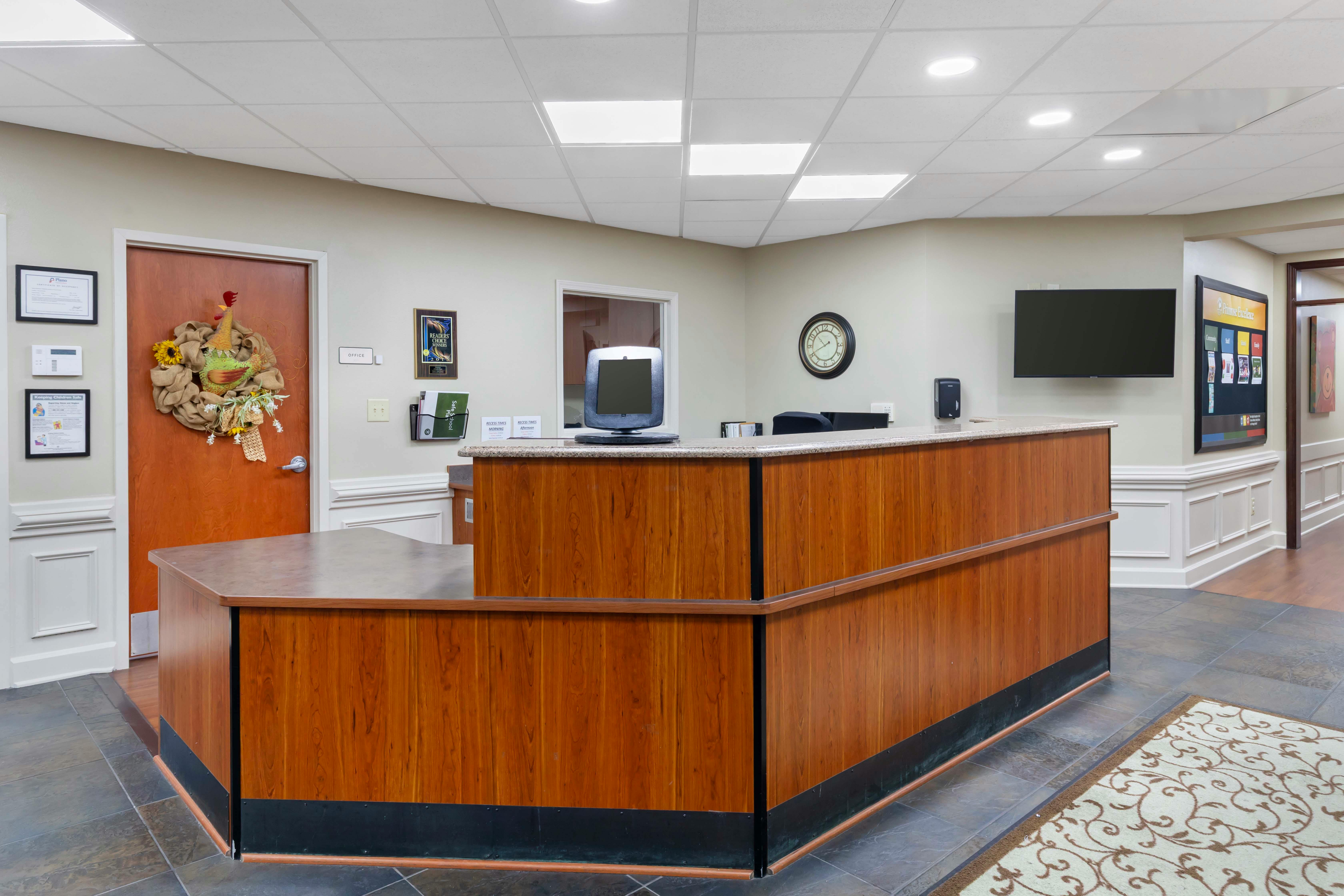 Reception area with a wooden desk and computer monitor
