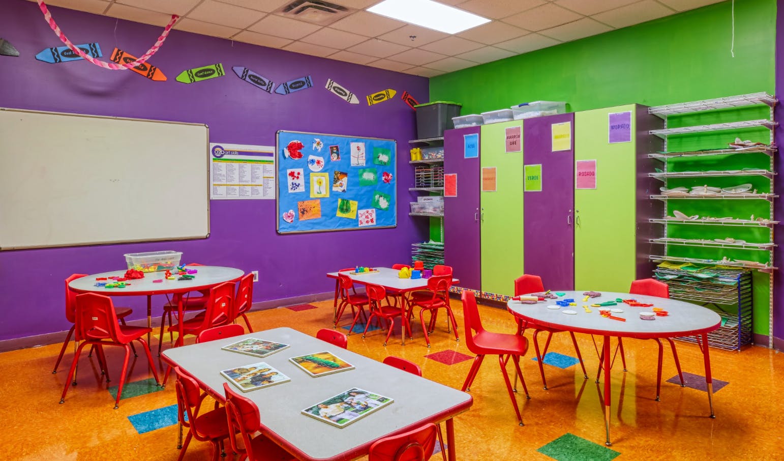 Colorful preschool classroom with small tables and chairs