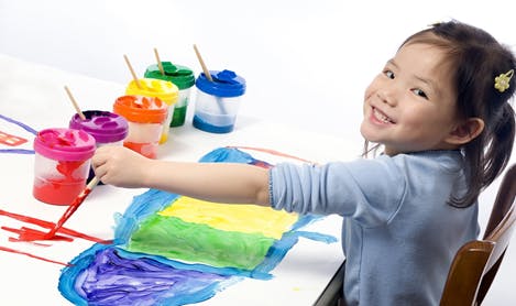 Child painting with multiple colors