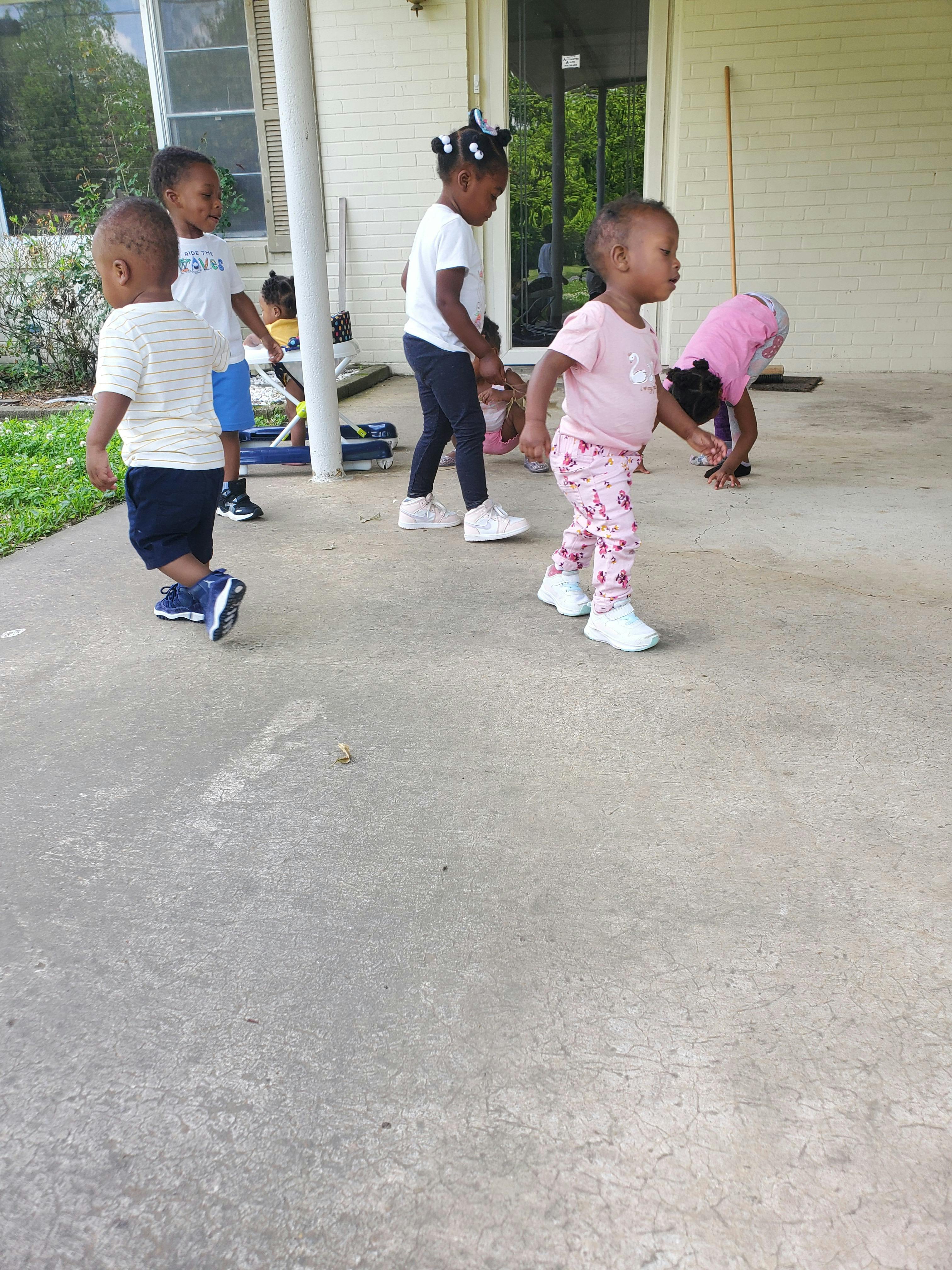 Multiple children playing on a porch