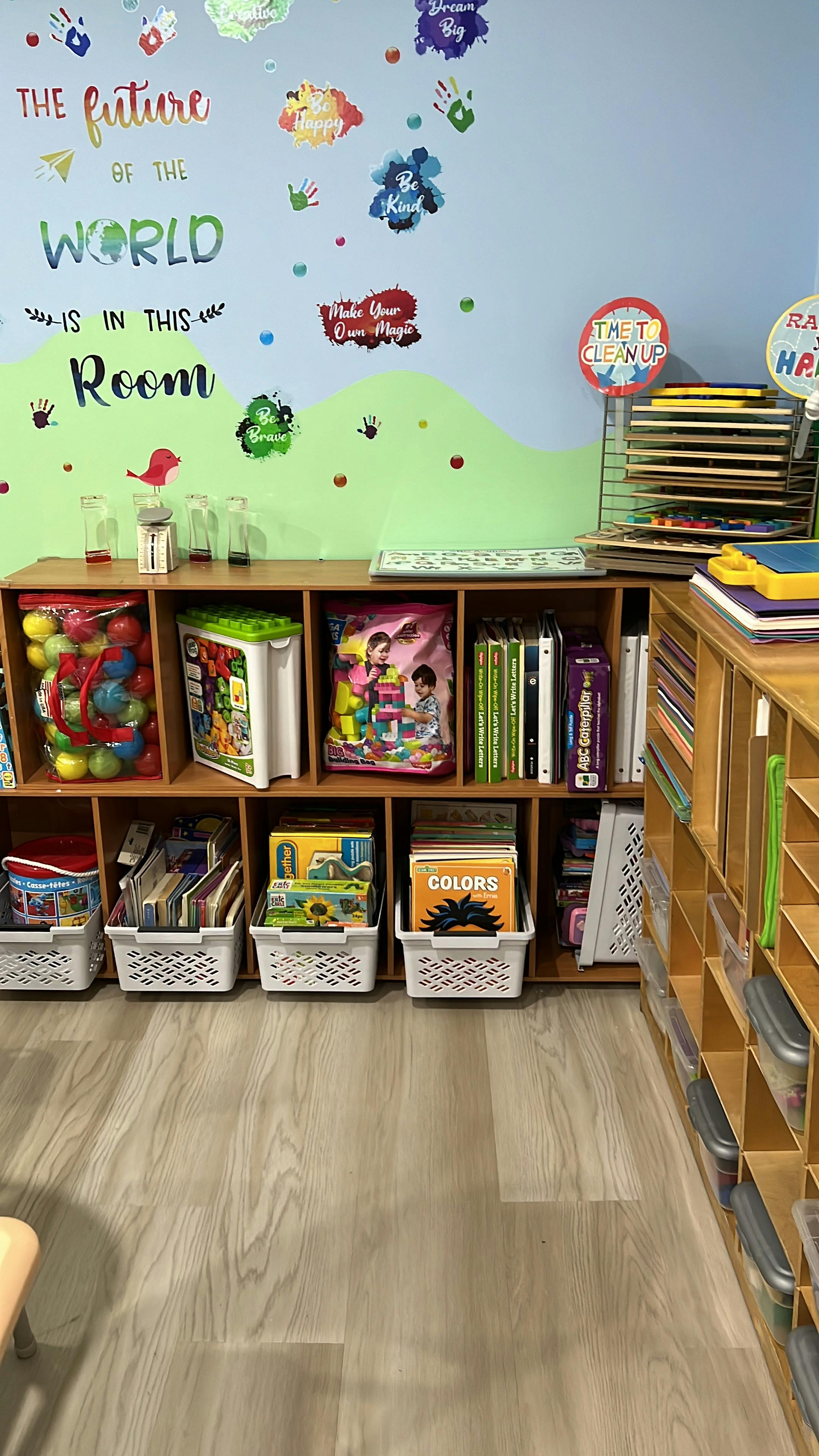 Classroom storage shelf with organized books and toys