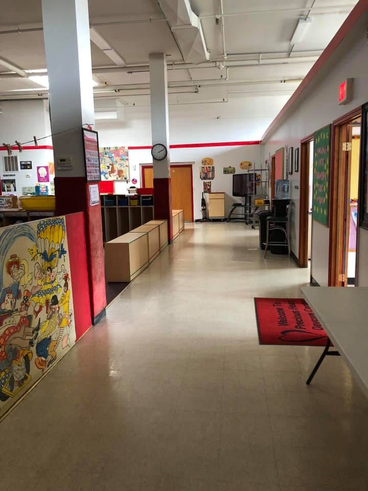 Hallway with red trim, doors, and storage units