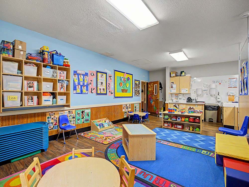 Colorful classroom with play areas and small tables