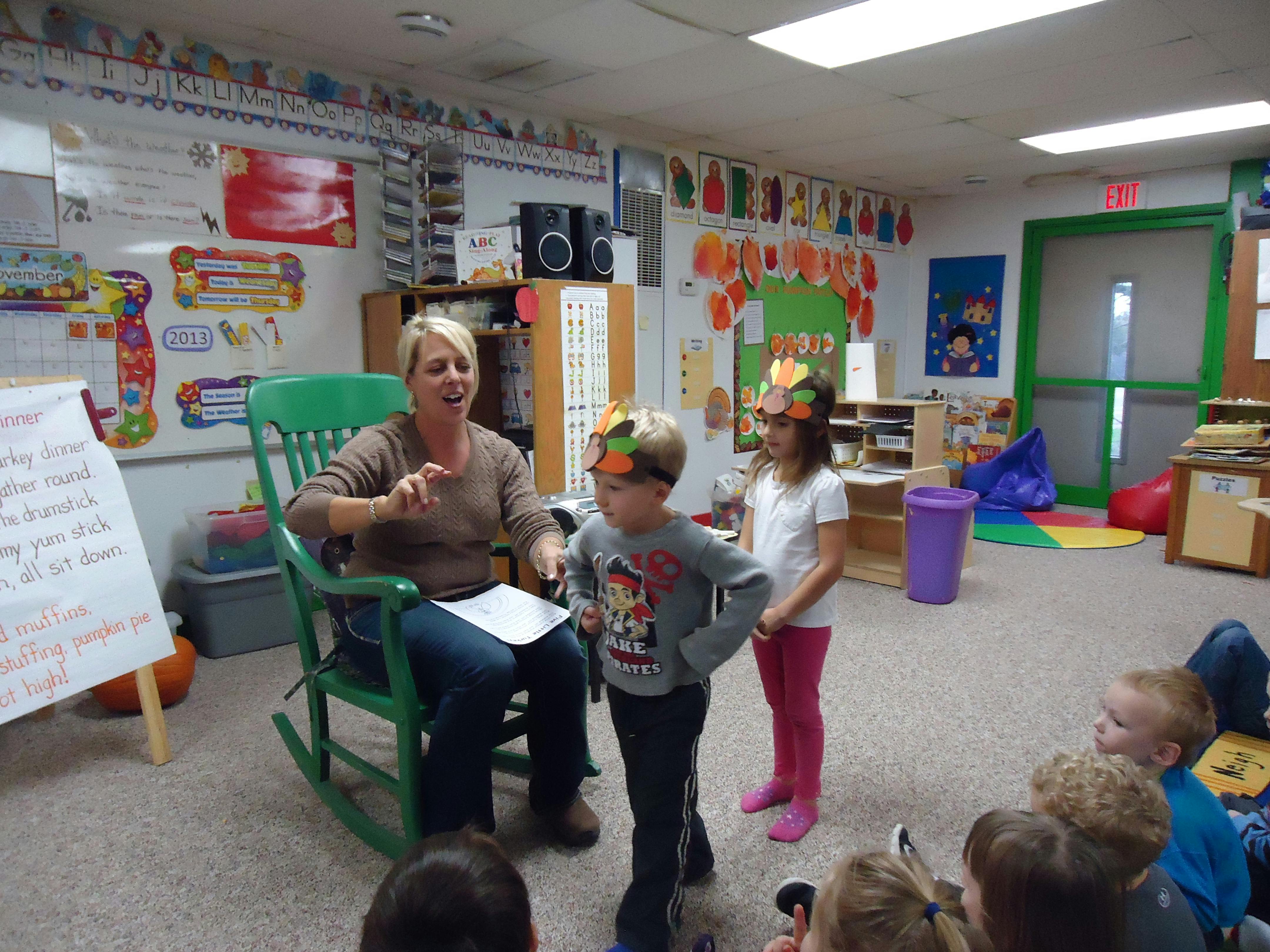 Adult speaking to children in a classroom