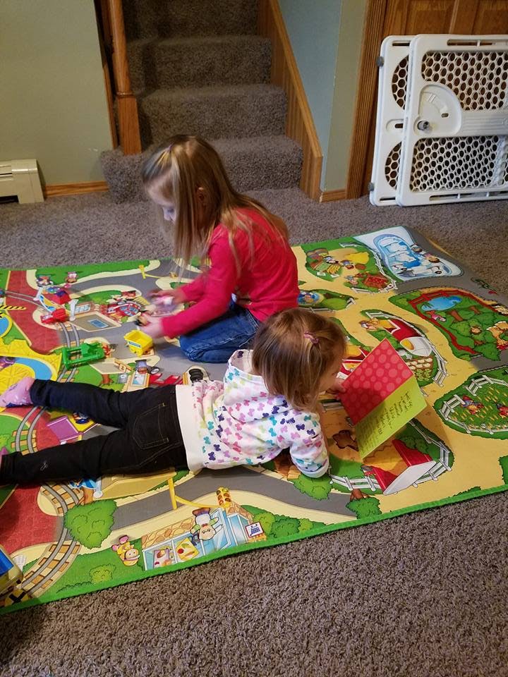 Two children playing on a colorful mat
