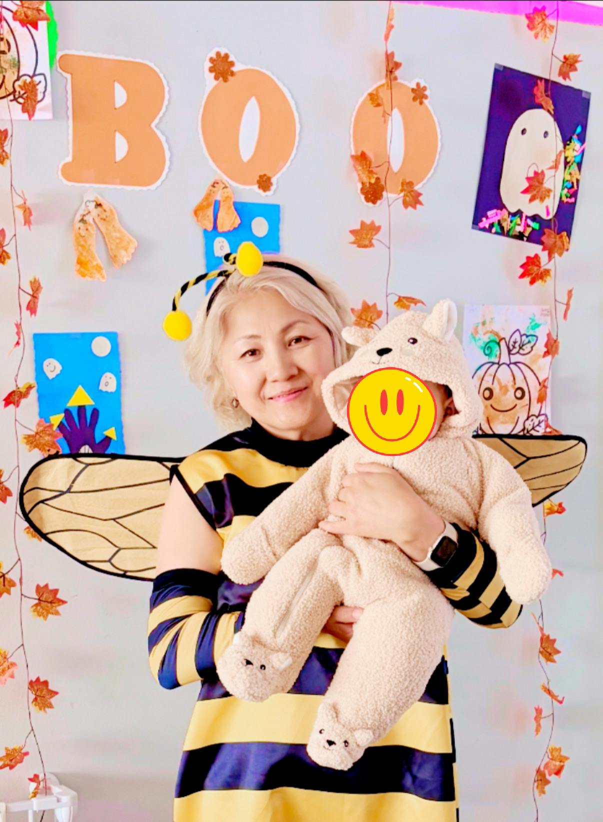 Person in bee costume holding a child in a bear costume