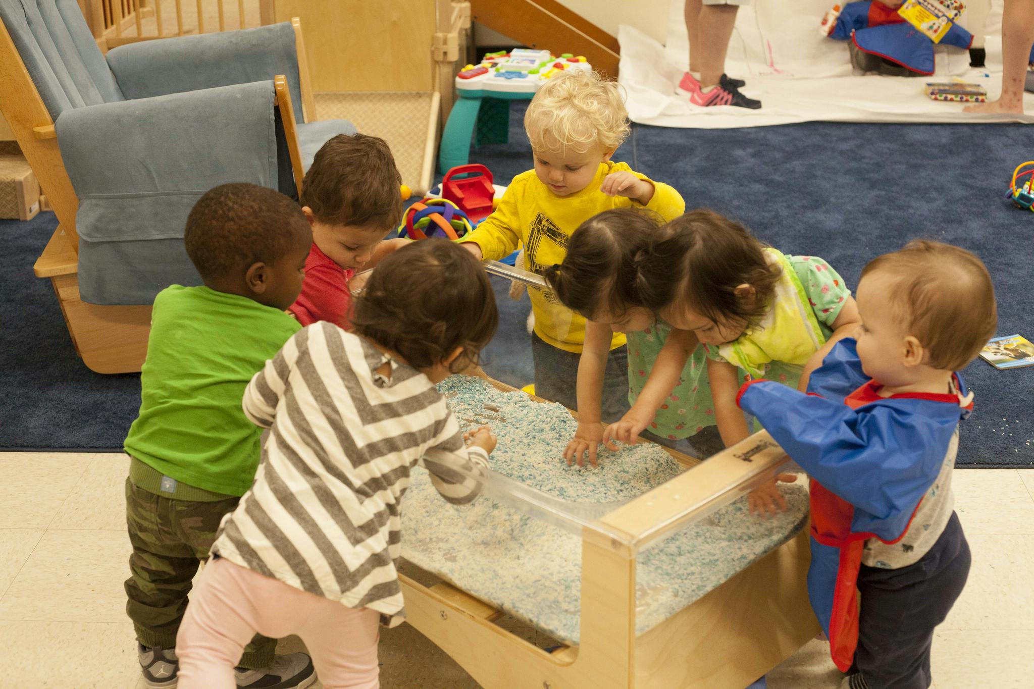 Group of children playing at a sensory table