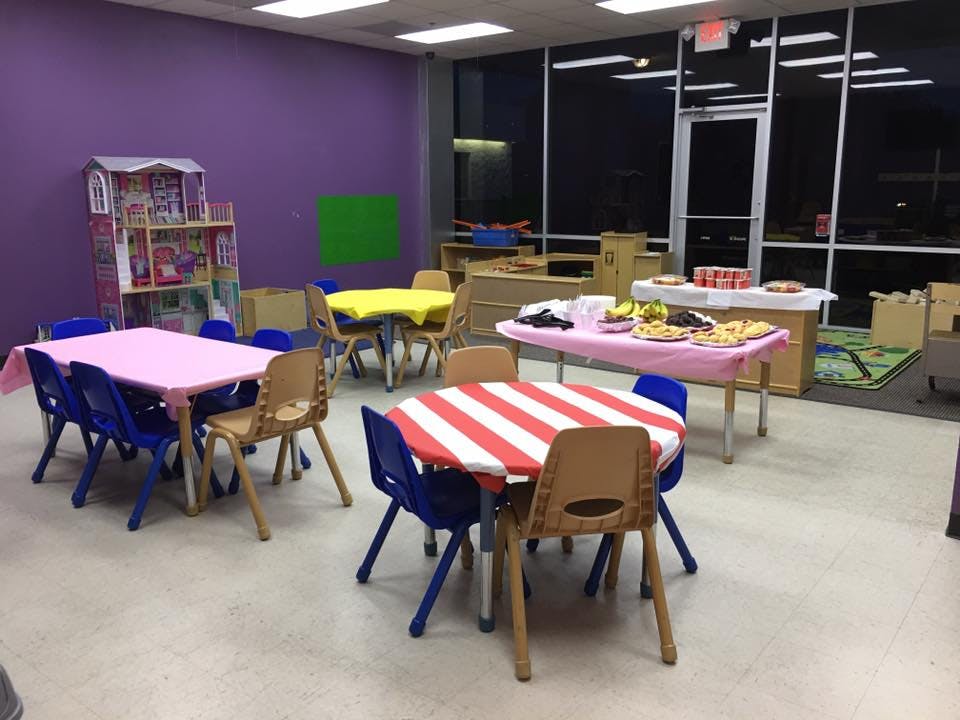 Children's tables and chairs in a room with purple walls