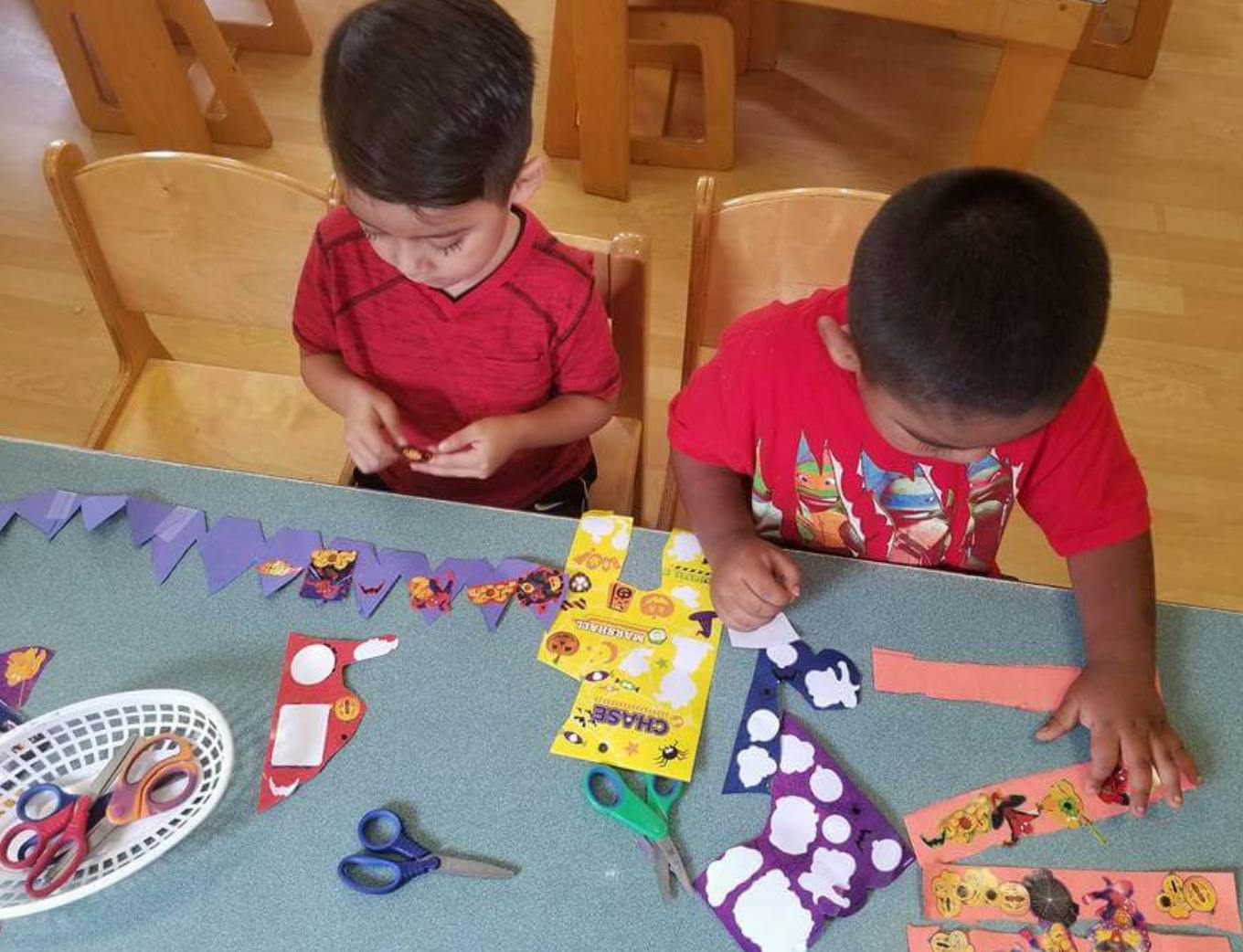 Two children doing crafts at a table
