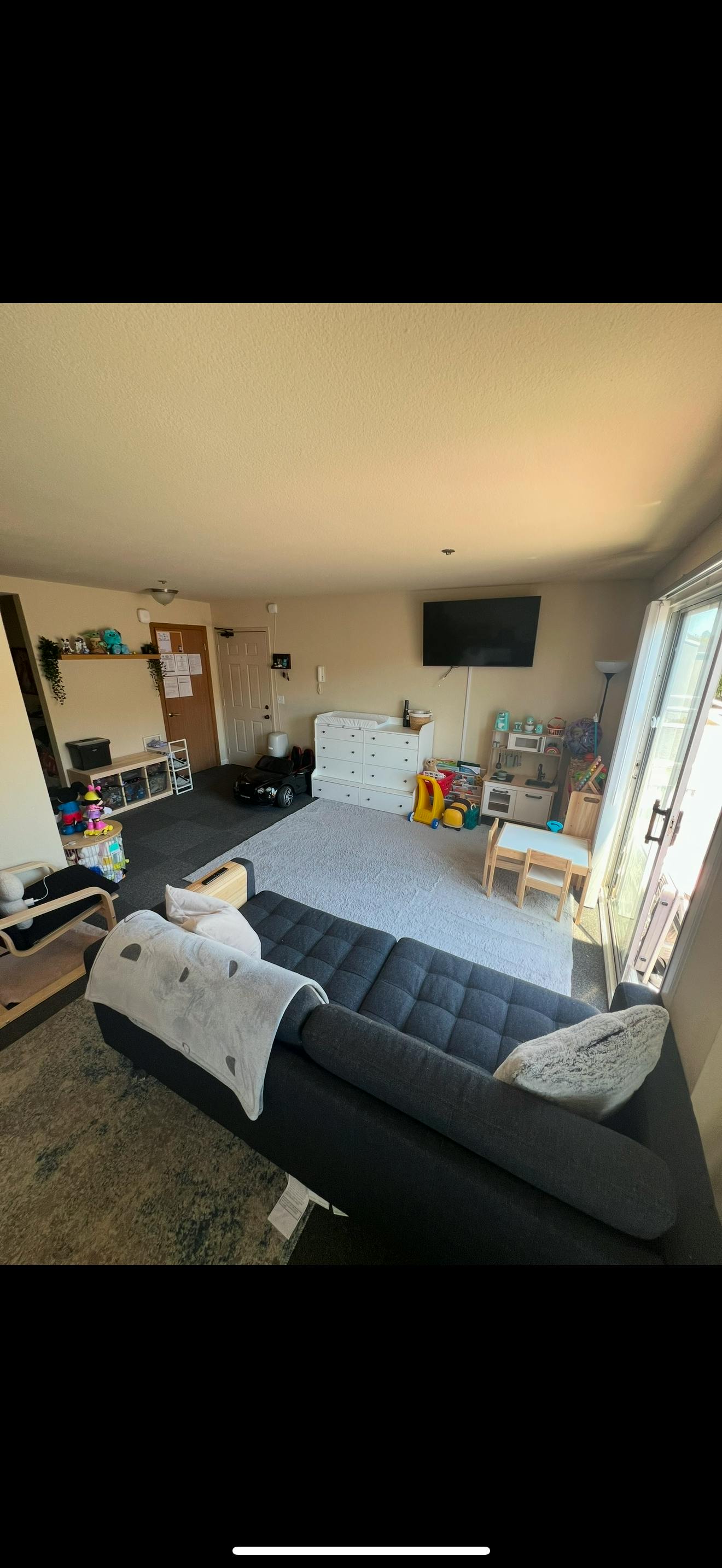 Living room arranged with children's toys and play furniture